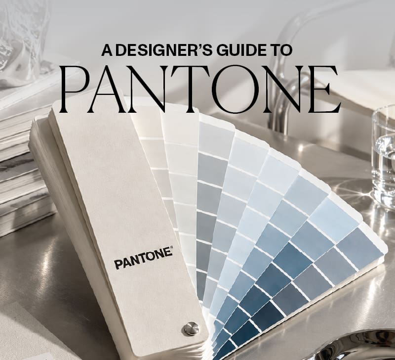 Pantone colour swatch guide on a silver design studio desk
