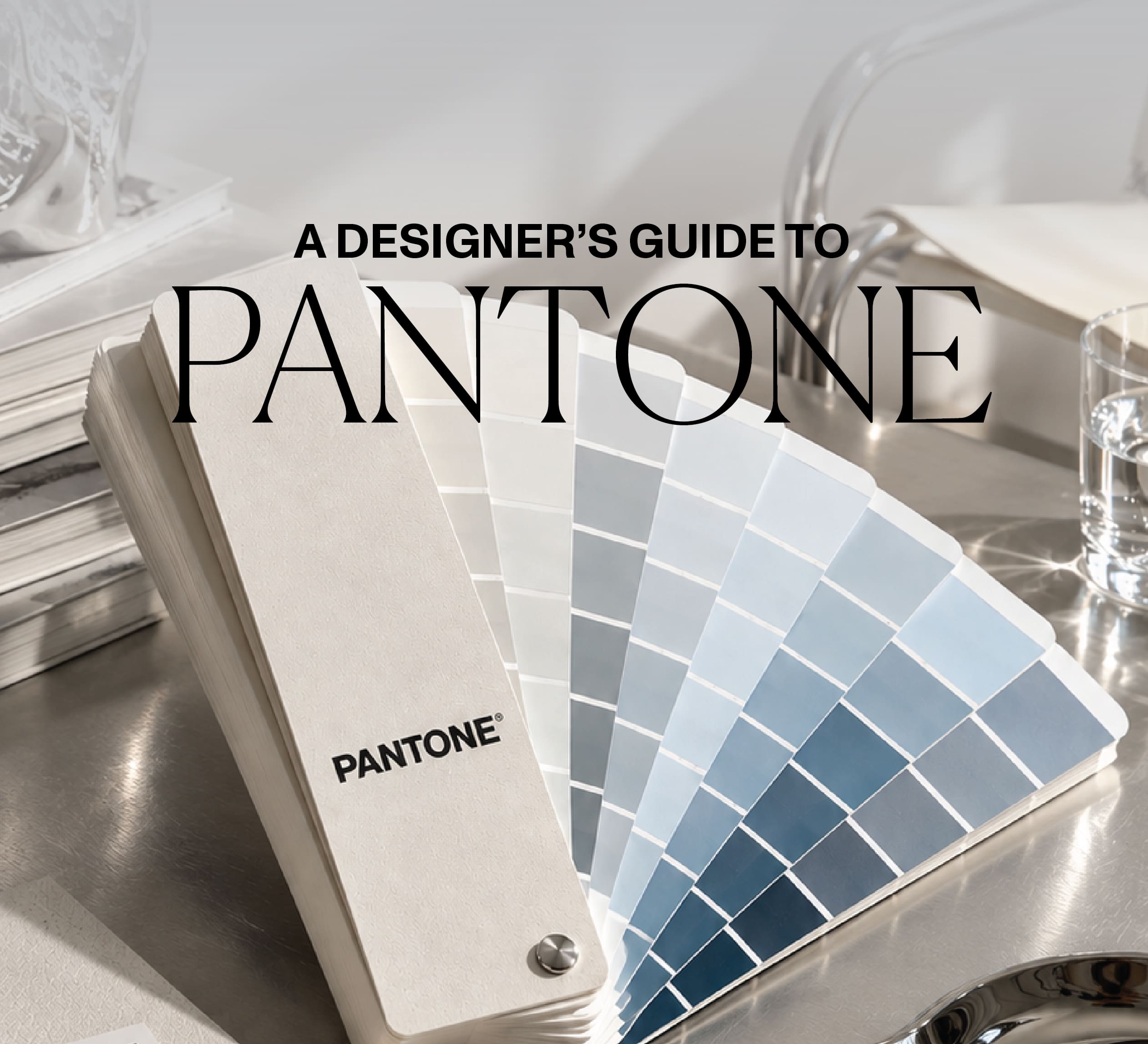 Pantone colour swatch guide on a silver design studio desk